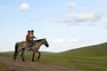 Mongolian Boys Riding Horse