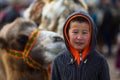 Mongolian child during annual national competition with birds of prey `Berkutchi` of West Mongolia.