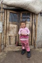 Mongolian child infront of Ger doors Royalty Free Stock Photo