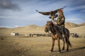 Mongolian eagle hunter with his eagle and horse