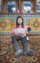 Mongolian girl inside her home ger with her pet baby sheep