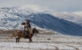 Mongolian horse rider in the mountains during the golden eagle festival