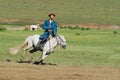 Mongolian man wearing traditional costume rides on horse back in a steppe in Kharkhorin, Mongolia. Royalty Free Stock Photo