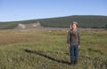 Mongolian nomad kid in a landscpae of northern Mongolia