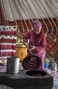 Mongolian nomad lady cooking in a her kitchen