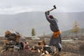 Mongolian nomad men cutting firewood