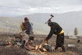 Mongolian nomad men cutting firewood