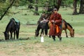 Mongolian shepherds with horses Royalty Free Stock Photo