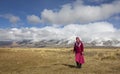 Mongolian woman outsie with snowy Altai maountains at the background