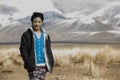 Mongolian woman outsie with snowy Altai maountains at the background