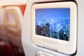 Monitor in front of passenger seat showing Panorama vire HongKong cityscape at night , Hong kong city