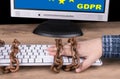 Close-up of hand and computer keyboard in old rusty chains on a wooden table Royalty Free Stock Photo