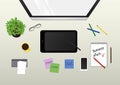 Monitor, graphic tablet, plant, coffee, phone and office supplies on the desktop. view from above Royalty Free Stock Photo