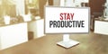 Monitor in modern office with STAY PRODUCTIVE text on the screen Royalty Free Stock Photo