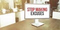 Monitor in modern office with Stop Making Excuses text on the screen