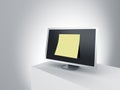 Monitor on a podium with oversized post it note. Royalty Free Stock Photo