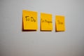 Monitor task of work concept, To do, In progress, Done Note reminder yellow sticker or post note on a white wall close up,. Royalty Free Stock Photo