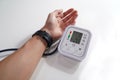 Monitoring blood pressure of patients using upper arm blood pressure monitor in the clinic examination room. Royalty Free Stock Photo