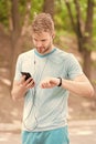 Monitoring and boosting his training. Sportsman tracking his training with fitbit and smartphone. Fit man paring