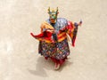 Monk in a bull deity mask with ritual dagger phurpa performs a religious masked and costumed Cham dance of Tibetan Buddhism