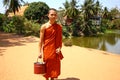 Monk in Cambodia bringing water