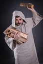 Monk carrying firewood threaten with chock for throw