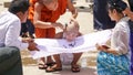 Monk child getting a haircut in public in Kalaw city, Myanmar / Burma.