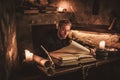 Monk chronicler writes an ancient manuscript Royalty Free Stock Photo