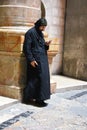 Monk in The Church of the Holy Sepulchre, Christ`s tomb, in the Old City of Jerusalem, Israel Royalty Free Stock Photo