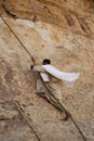 A monk climbing a rope to the Dobre Damo Monastery