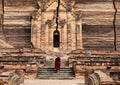 A monk coming to ancient pagoda in Mandalay, Myanmar