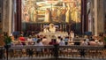 Monk drinks from golden cup during communion during general worship service on the top floor of Church of the Annunciation in the