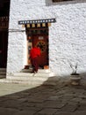 Monk entering the house at Simtokha Dzong in Bhutan Royalty Free Stock Photo