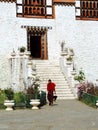 Monk at the entrance of Simtokha Dzong in Bhutan