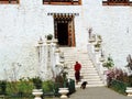 Monk at the entrance of Simtokha Dzong in Bhutan