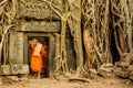 Monk exiting the doorway of Ta Prohm, Angkor Wat, Camboda