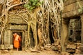 Monk exiting the doorway of Ta Prohm, Angkor Wat, Camboda