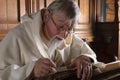Monk with feather quill Royalty Free Stock Photo