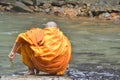 Monk feeding fish soft focus