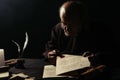 monk holding wax seal and manuscripts