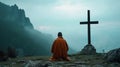 A monk kneeling in prayer in front of a simple wooden cross surrounded by the serene tranquility of the mountain Royalty Free Stock Photo