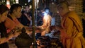 monk light candle for people in Yeepeng or Loy Krathong festival Royalty Free Stock Photo