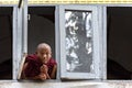 Monk looking out the window, Yangon, Myanmar