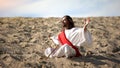 Monk in lotus pose raising hands to sky, praying to God in desert, meditation Royalty Free Stock Photo