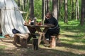 Monk in medieval clothes waiting dinner in camp. Royalty Free Stock Photo