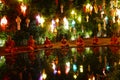 Monk meditate beside the pond among the colorful paper lantern i