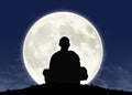 Monk in meditation at the full moon