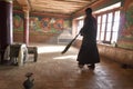 The monk in the monastery prepare to clean it before the evening prayer in Korzok Monastery