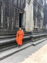 Monk in Orange Robe on Mobile Phone at Angkor Wat