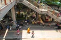 A monk among other pedestrians passes by the stalls in Victory Monument in Bangkok, Thailand